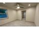 Neutral bedroom with ceiling fan, tiled floor, and open door to bath at 3572 Adkins Nw Rd, Atlanta, GA 30331