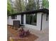 Charming exterior view of a painted white brick home with dark window trim and professionally landscaped yard at 3572 Adkins Nw Rd, Atlanta, GA 30331