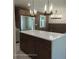Kitchen with island, stainless steel refrigerator and modern lighting fixtures at 3572 Adkins Nw Rd, Atlanta, GA 30331