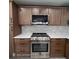 Modern kitchen with stainless steel range and oven, stylish backsplash, and light wood cabinets at 3572 Adkins Nw Rd, Atlanta, GA 30331