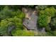 A high aerial view shows a sprawling home with lush greenery all around at 5251 Powers Ferry Rd, Atlanta, GA 30327