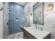Modern bathroom featuring decorative tile shower and a stylish vanity at 5251 Powers Ferry Rd, Atlanta, GA 30327