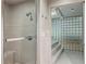 Bathroom with a glass enclosed shower and glass block wall at 5251 Powers Ferry Rd, Atlanta, GA 30327
