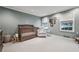 Bedroom with crib, chair, windows with blinds, and grey walls at 5251 Powers Ferry Rd, Atlanta, GA 30327
