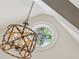 Unique chandelier fixture with an eye-catching design, complemented by a round window and an arched ceiling at 5251 Powers Ferry Rd, Atlanta, GA 30327