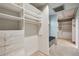 Long walk-in closet with built-in shelves and drawers at 5251 Powers Ferry Rd, Atlanta, GA 30327