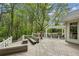 Expansive deck with multiple seating areas, pergola, and lovely wooded views at 5251 Powers Ferry Rd, Atlanta, GA 30327