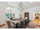 Elegant dining area showcasing a chandelier and hardwood floors, with an open view into the inviting living room at 5251 Powers Ferry Rd, Atlanta, GA 30327