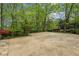 Large paved driveway area providing ample parking space and surrounded by a serene wooded setting at 5251 Powers Ferry Rd, Atlanta, GA 30327