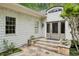 Close up of the home's entrance featuring a stone pathway, tiled landing, and stylish double doors at 5251 Powers Ferry Rd, Atlanta, GA 30327