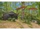 Charming cottage-style home nestled in a lush, wooded landscape with mature trees at 5251 Powers Ferry Rd, Atlanta, GA 30327