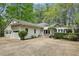 An inviting exterior showcasing a charming home with a 2-car garage and beautiful landscaping at 5251 Powers Ferry Rd, Atlanta, GA 30327