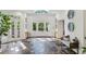 Bright foyer with stone floors, skylight, and grand entry doors offer an open, airy feel with natural light at 5251 Powers Ferry Rd, Atlanta, GA 30327