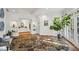 Elegant foyer featuring natural stone flooring, a glimpse of the bright living area, and ample natural light at 5251 Powers Ferry Rd, Atlanta, GA 30327