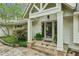 Inviting entrance with stone steps, detailed trim, and lush greenery, creating a warm and welcoming approach at 5251 Powers Ferry Rd, Atlanta, GA 30327