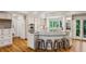 Spacious kitchen featuring hardwood floors, an island with bar seating, and stainless steel appliances at 5251 Powers Ferry Rd, Atlanta, GA 30327