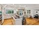 Bright kitchen showcasing hardwood floors, an island with seating, and stainless appliances near the living area at 5251 Powers Ferry Rd, Atlanta, GA 30327
