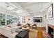 Bright living room with fireplace, large windows, and built-in shelving, perfect for gatherings and relaxation at 5251 Powers Ferry Rd, Atlanta, GA 30327
