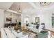 Spacious living area with hardwood floors, modern lighting fixtures, and seamless flow into the adjacent dining space at 5251 Powers Ferry Rd, Atlanta, GA 30327