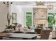 Cozy living room showcasing a striking stone fireplace, lush greenery, and elegant decor for comfortable living at 5251 Powers Ferry Rd, Atlanta, GA 30327