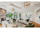 Bright living room with a stone fireplace, hardwood floors, and large windows offering serene views of the surrounding nature at 5251 Powers Ferry Rd, Atlanta, GA 30327