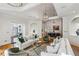 Open-concept living area with hardwood floors, elegant furnishings, and direct views into the dining area beyond at 5251 Powers Ferry Rd, Atlanta, GA 30327