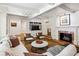 Inviting living room featuring fireplace, large windows, and built-in media cabinet for cozy, stylish living at 5251 Powers Ferry Rd, Atlanta, GA 30327