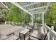 Relaxing outdoor patio with pergola, comfortable seating, and views of the surrounding trees at 5251 Powers Ferry Rd, Atlanta, GA 30327
