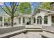 Rear exterior of the house with deck, outdoor seating, and lush greenery at 5251 Powers Ferry Rd, Atlanta, GA 30327
