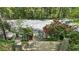 View of the tennis court from the house, surrounded by lush greenery at 5251 Powers Ferry Rd, Atlanta, GA 30327