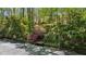 Tennis court and steps leading to the court, with lush landscaping at 5251 Powers Ferry Rd, Atlanta, GA 30327