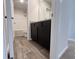 Bathroom featuring a dark vanity and wood-look flooring at 678 Egrets Landing #63, Covington, GA 30014