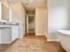 Bathroom featuring a soaking tub, white cabinets and granite countertops at 678 Egrets Landing #63, Covington, GA 30014