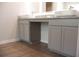 Bright bathroom featuring double sinks with granite counters and gray cabinetry at 678 Egrets Landing #63, Covington, GA 30014