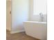 A bathroom with a modern white standalone tub and a glassed shower enclosure at 678 Egrets Landing #63, Covington, GA 30014