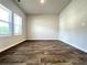 Bright bedroom with ample natural light, wood-look floors, and neutral walls for a peaceful retreat at 678 Egrets Landing #63, Covington, GA 30014