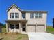 Two-story brick home featuring a two-car garage and classic black shutters at 678 Egrets Landing #63, Covington, GA 30014