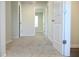 Hallway featuring neutral-toned walls and plush carpeting throughout the home at 678 Egrets Landing #63, Covington, GA 30014