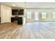 Modern kitchen with stainless steel appliances, dark cabinets, and an open layout to the dining area at 678 Egrets Landing #63, Covington, GA 30014