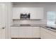 Close up of kitchen featuring granite countertops, white cabinets, and subway tile backsplash at 678 Egrets Landing #63, Covington, GA 30014