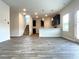 Open-concept kitchen featuring dark cabinets, stainless appliances, modern pendant lights and durable flooring at 678 Egrets Landing #63, Covington, GA 30014