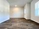 Spacious living room featuring durable floors, neutral walls, and a view of the back yard at 678 Egrets Landing #63, Covington, GA 30014