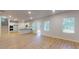Open concept living room with white walls, wood floors, kitchen and staircase at 678 Egrets Landing #63, Covington, GA 30014