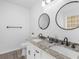 Bathroom with double granite vanity and framed mirrors at 135 Kimbell Farm Dr, Locust Grove, GA 30248