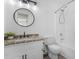 Bathroom with granite vanity, framed mirror, and shower with tile surround at 135 Kimbell Farm Dr, Locust Grove, GA 30248