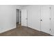 Bedroom with neutral carpet and two closets with doors at 135 Kimbell Farm Dr, Locust Grove, GA 30248