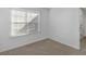 Neutral bedroom with carpet, a bright window, and a clean, minimalist style at 135 Kimbell Farm Dr, Locust Grove, GA 30248