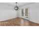 Cozy dining area with hardwood floors, modern lighting, and a view of the backyard through French doors at 135 Kimbell Farm Dr, Locust Grove, GA 30248