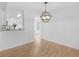 Dining area with hardwood floors, chandelier, and convenient access to the kitchen at 135 Kimbell Farm Dr, Locust Grove, GA 30248