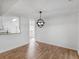 Bright dining area with hardwood floors, modern lighting, and open access to the kitchen at 135 Kimbell Farm Dr, Locust Grove, GA 30248